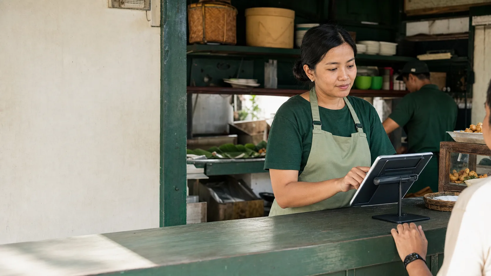 An Indonesian business owner managing her store from the counter